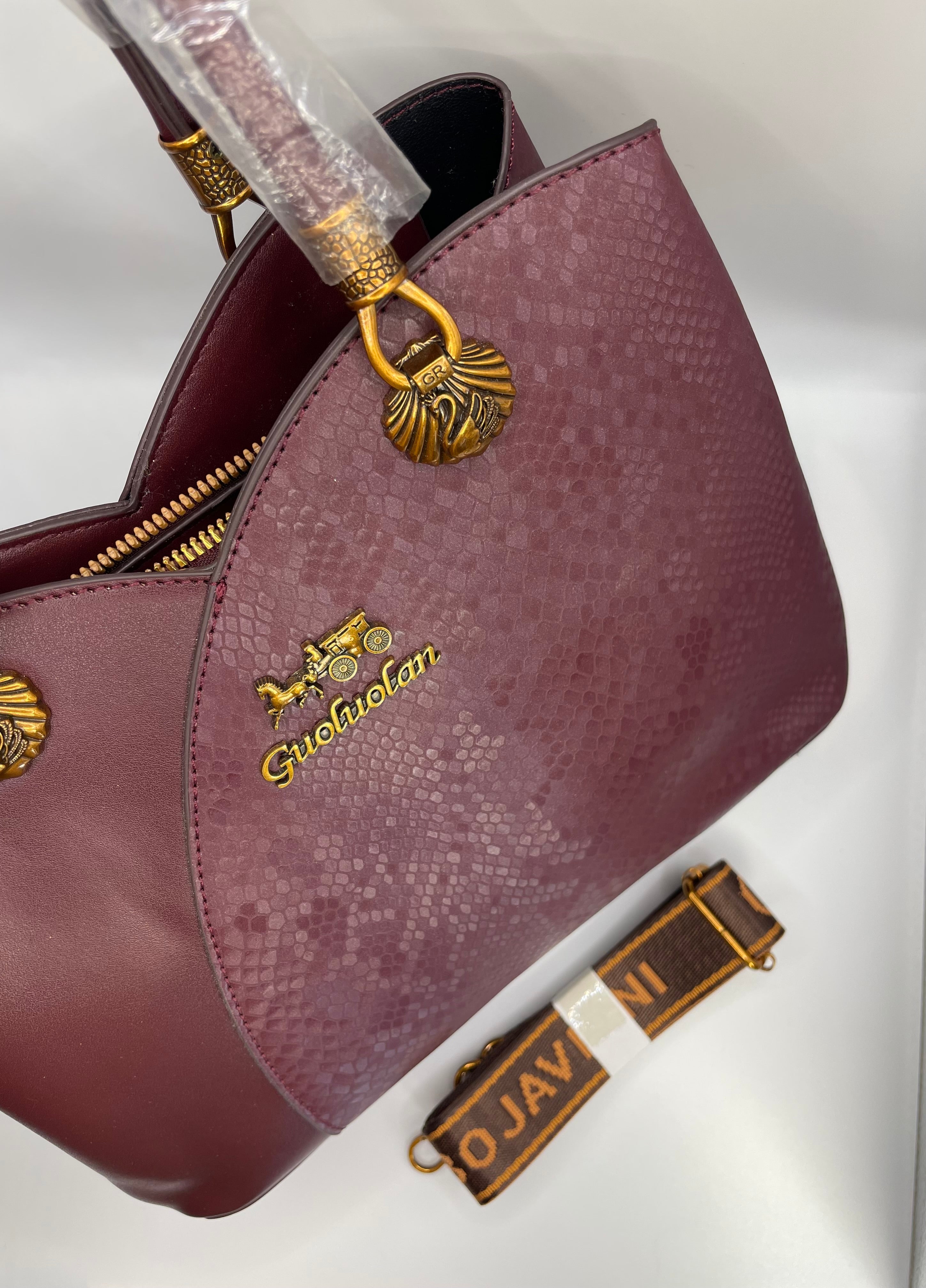 This is a Guoluolan burgundy top handle bag with a snakeskin-textured panel.